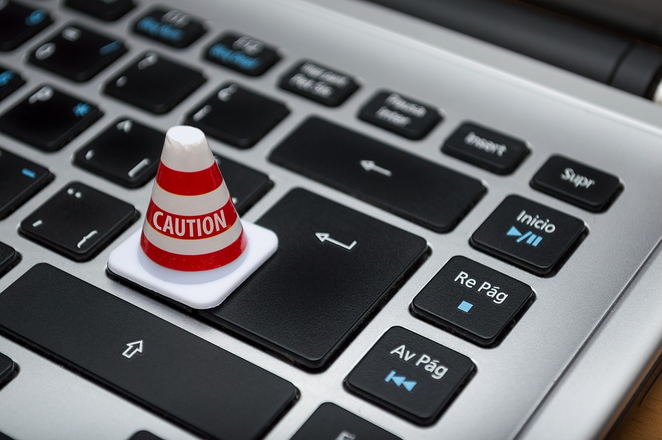 Caution cone on computer keyboard